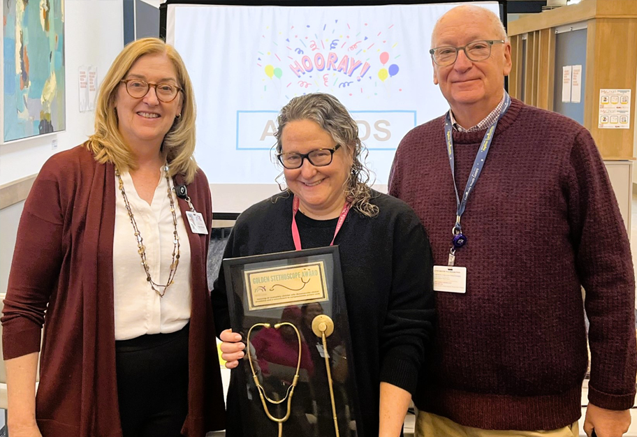 Photo of Dr. Toolan celebrated for clinical excellence along with colleagues